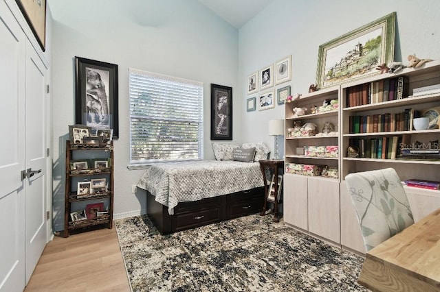 bedroom featuring light wood-type flooring and a closet