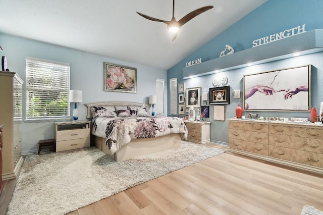 bedroom featuring light hardwood / wood-style floors, ceiling fan, and lofted ceiling