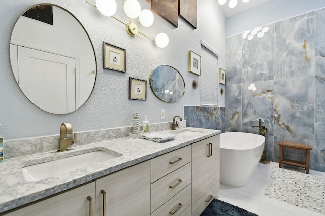 bathroom featuring a tub to relax in, vanity, and tile walls