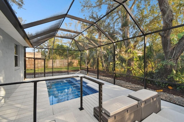 view of swimming pool featuring a lanai and a patio area