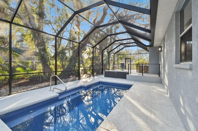 view of swimming pool with a lanai