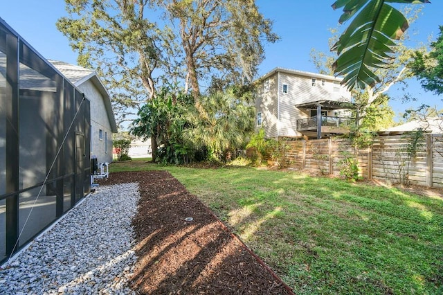 view of yard with glass enclosure