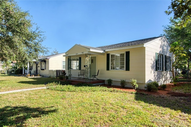 ranch-style home with a porch and a front yard