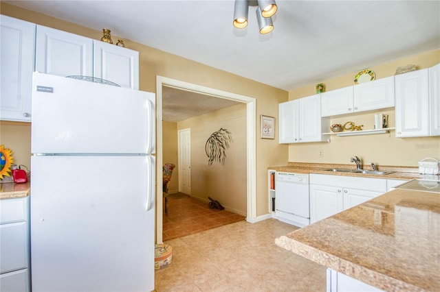 kitchen with sink, white cabinets, and white appliances