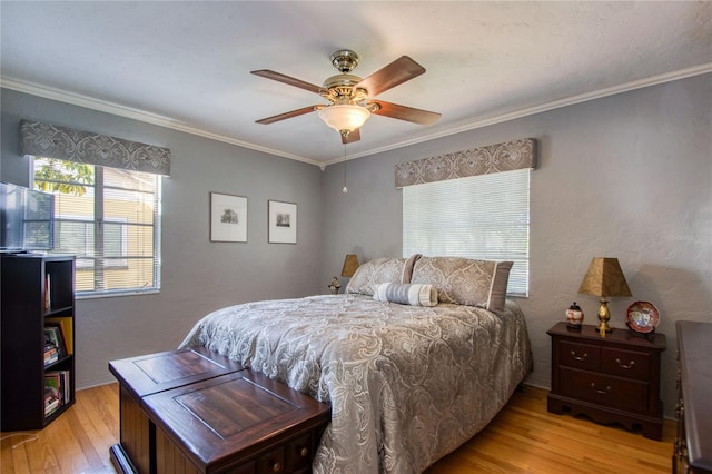 bedroom with ceiling fan, ornamental molding, and light wood-type flooring