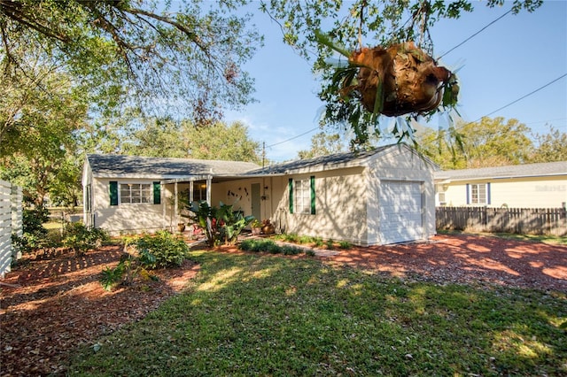 single story home featuring a front lawn and a garage