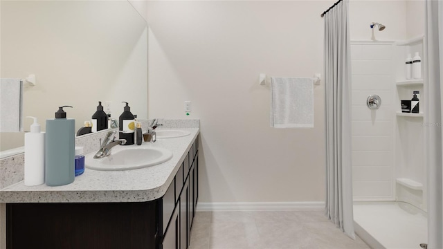 bathroom featuring tile patterned floors, a shower, and vanity