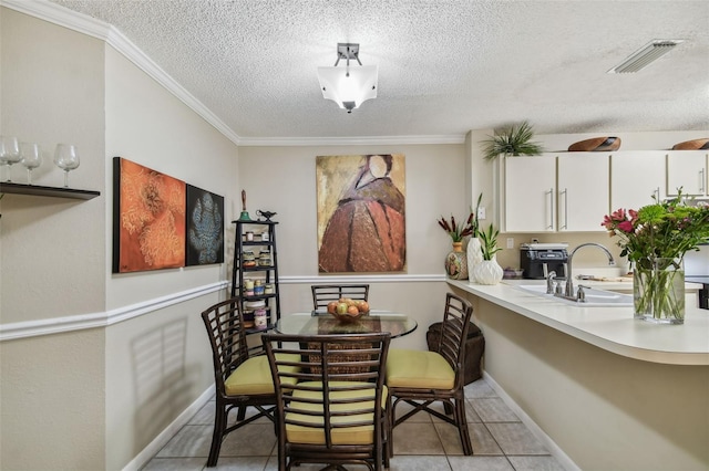 tiled dining space with ornamental molding and a textured ceiling