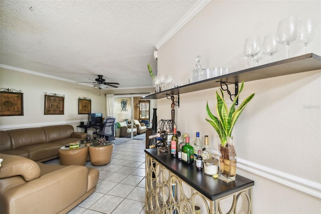 living room featuring a textured ceiling, ceiling fan, and crown molding