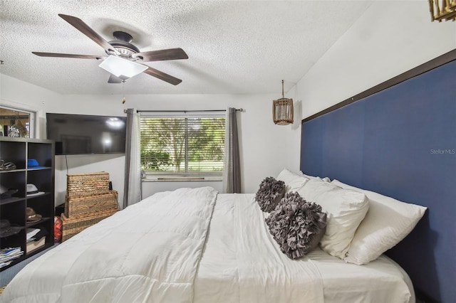 bedroom with a textured ceiling and ceiling fan