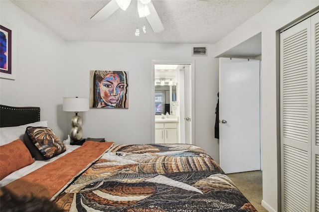 carpeted bedroom with ceiling fan, a textured ceiling, and a closet