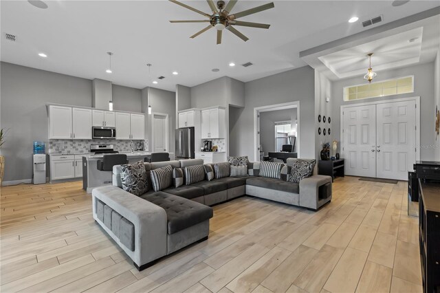 living room featuring a high ceiling and ceiling fan