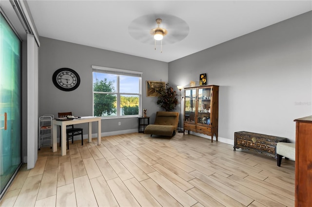 sitting room featuring ceiling fan and light wood-type flooring