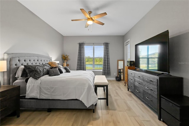 bedroom with ceiling fan and light wood-type flooring