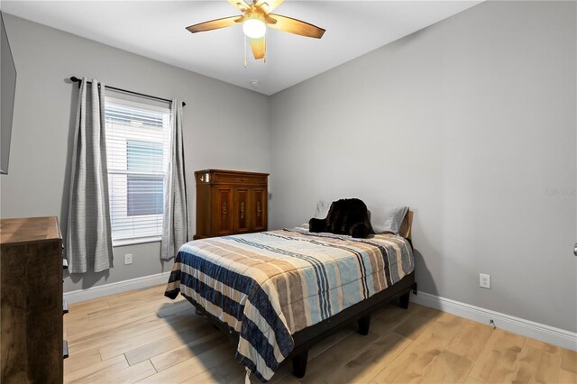 bedroom featuring ceiling fan and light hardwood / wood-style flooring