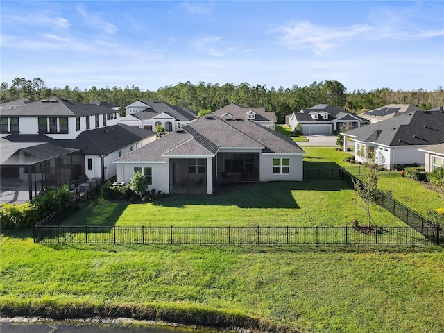 rear view of property with a lawn