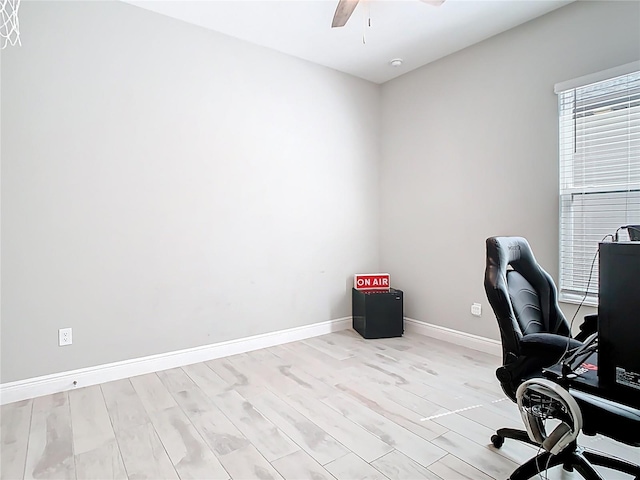 office space with wood finished floors, a ceiling fan, and baseboards