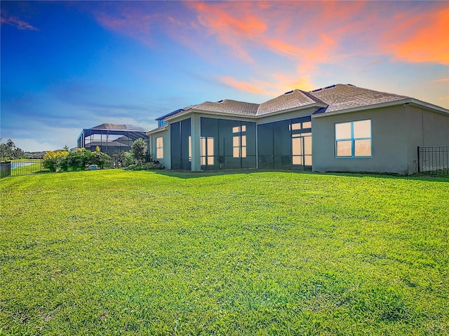 3901 Tour Trce, Land O Lakes, FL 34638 - back of property with stucco siding, a sunroom, and roof with shingles