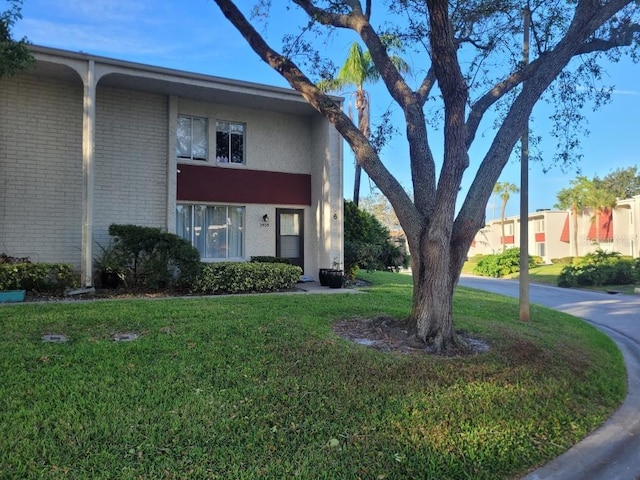 view of side of property with a yard