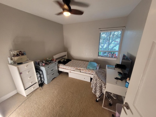 bedroom featuring light carpet and ceiling fan