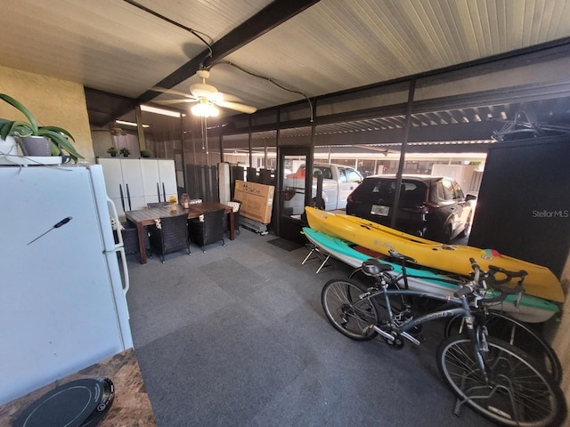 garage featuring white fridge and ceiling fan