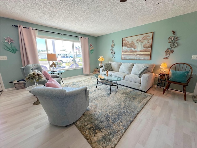 living room featuring light hardwood / wood-style flooring and a textured ceiling