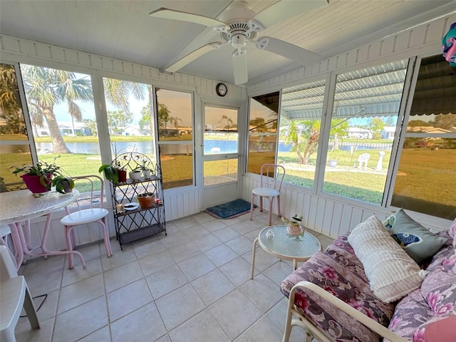 sunroom featuring a water view, ceiling fan, and lofted ceiling