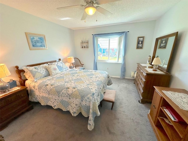 carpeted bedroom featuring a textured ceiling and ceiling fan