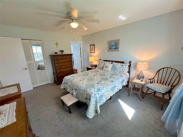 bedroom featuring ceiling fan, carpet, and a textured ceiling