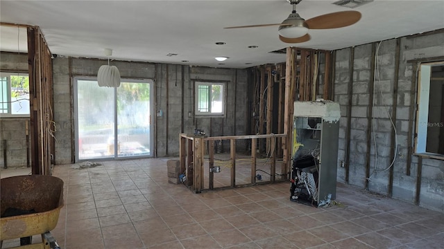 interior space featuring a wealth of natural light, tile patterned floors, and ceiling fan