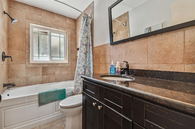 bathroom featuring tile patterned floors, shower / bath combo, toilet, tile walls, and vanity