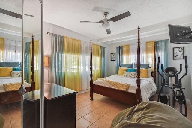 bedroom featuring ceiling fan, light tile patterned floors, and multiple windows