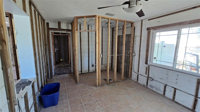 miscellaneous room featuring ceiling fan, tile patterned floors, a textured ceiling, and visible vents