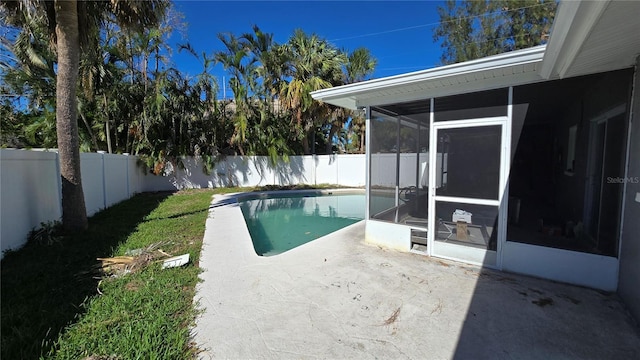 view of swimming pool with a fenced in pool, a sunroom, a patio, and a fenced backyard