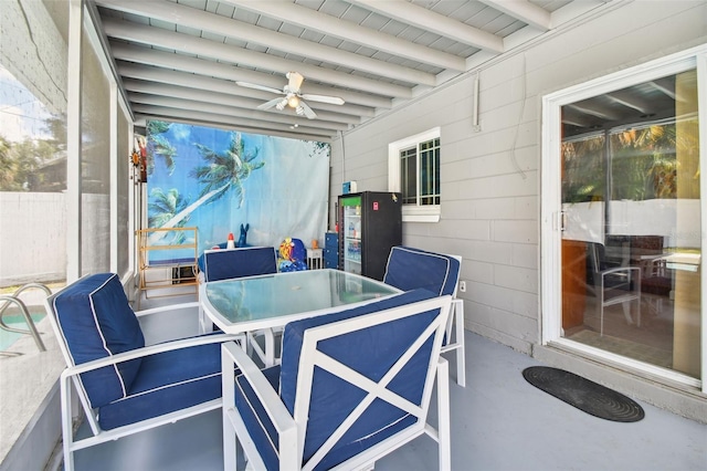 sunroom with beamed ceiling, outdoor dining space, and ceiling fan