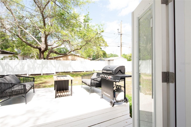 deck with an outdoor living space and a grill