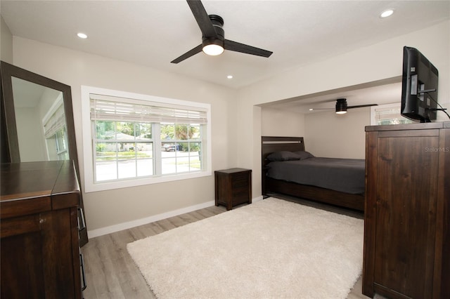 bedroom with ceiling fan and light wood-type flooring