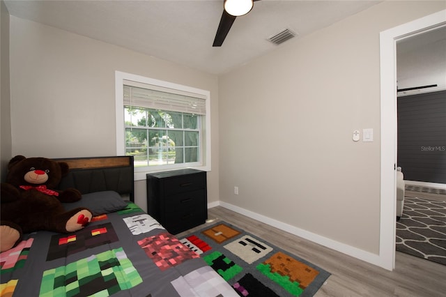 bedroom with hardwood / wood-style flooring and ceiling fan