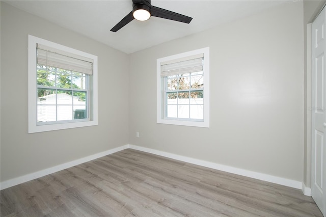 unfurnished room with light hardwood / wood-style floors, ceiling fan, and a healthy amount of sunlight