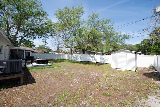 view of yard with a patio, a storage unit, and central air condition unit