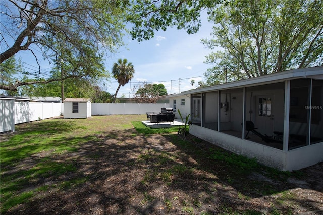 view of yard with a patio, a shed, and a sunroom