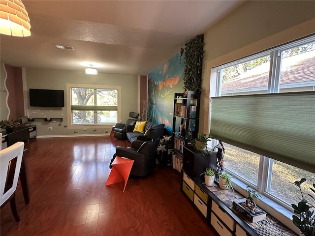 living room featuring dark hardwood / wood-style flooring and a textured ceiling