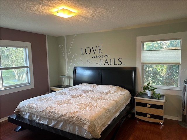 bedroom featuring a textured ceiling and hardwood / wood-style flooring