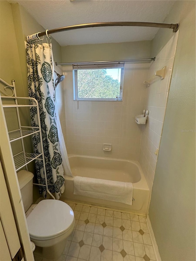 bathroom featuring tile patterned flooring, toilet, and shower / bathtub combination with curtain