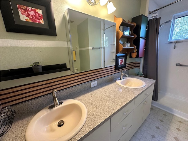 bathroom with a shower with curtain and vanity