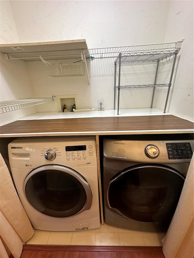 clothes washing area with washing machine and clothes dryer