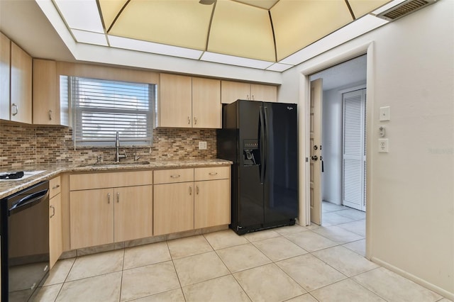 kitchen with decorative backsplash, light brown cabinetry, sink, black appliances, and light tile patterned floors