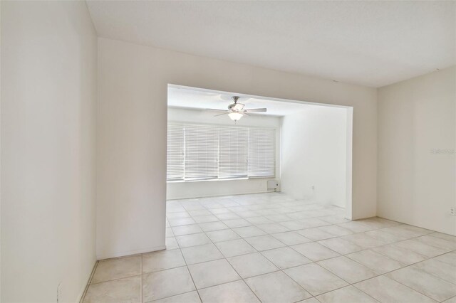 empty room with light tile patterned floors and ceiling fan