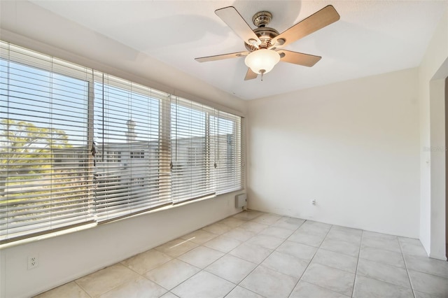 unfurnished room featuring light tile patterned floors and ceiling fan