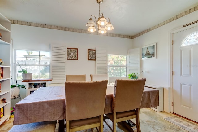 dining area with plenty of natural light and a notable chandelier